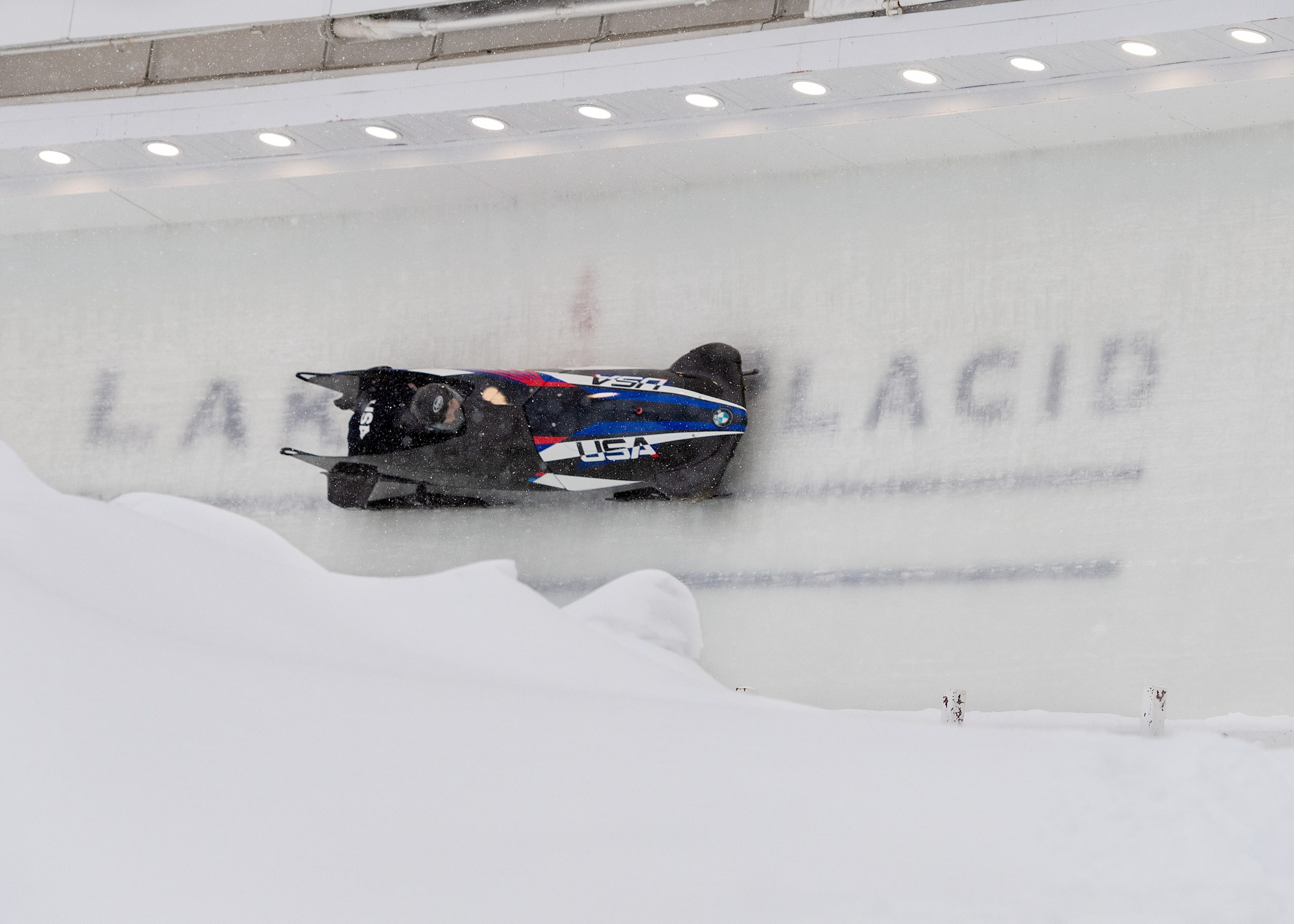 A Team USA two person bobsled speeding down the track at Mt Van Hoevenberg.