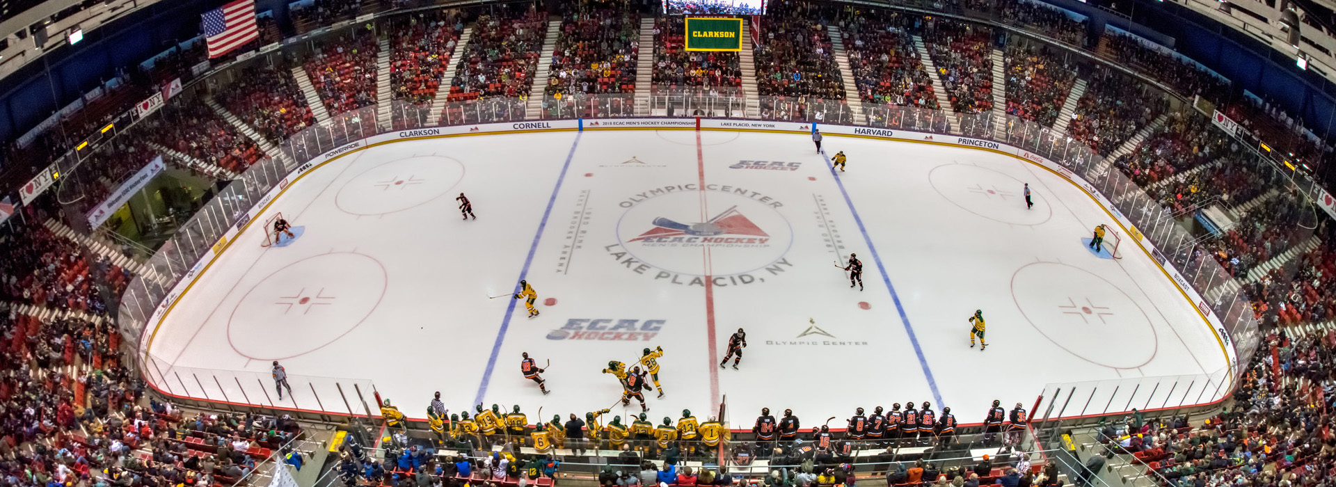 Hockey players on the ice below battle it out with a big crowd cheering inside the Olympic Center's 1980 Herb Brooks Arena.
