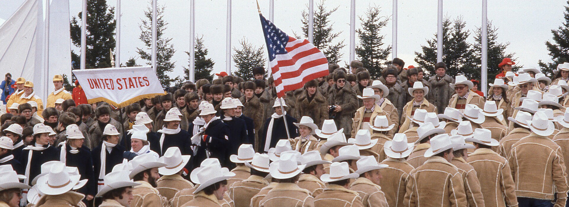 Scott Hamilton holds the U.S. flag as he walks surrounded by other members of Team USA in the opening ceremonies of the 1980 Winter Olympic Games.
