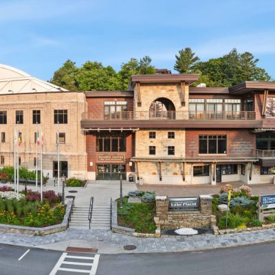 A portion of the Olympic Center in downtown Lake Placid featuring the 1932 rink entrance at the left and the Conference Center entrance to the right in daytime during summer.