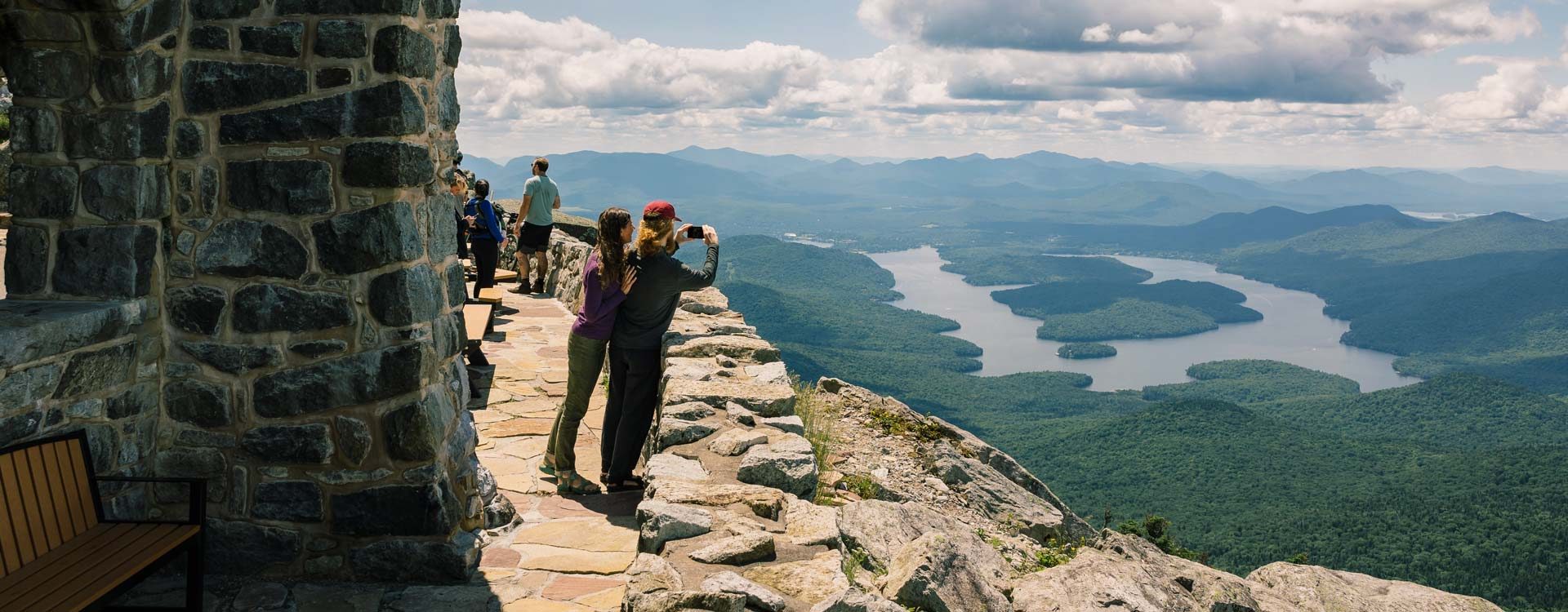 Sightseers taking a picture of Lake Placid from the top of the Whiteface Veterans' Memorial Highway.