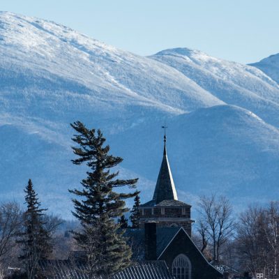 The Village of Lake Placid in the foreground with the Adirondack High Peaks in Winter in the background.